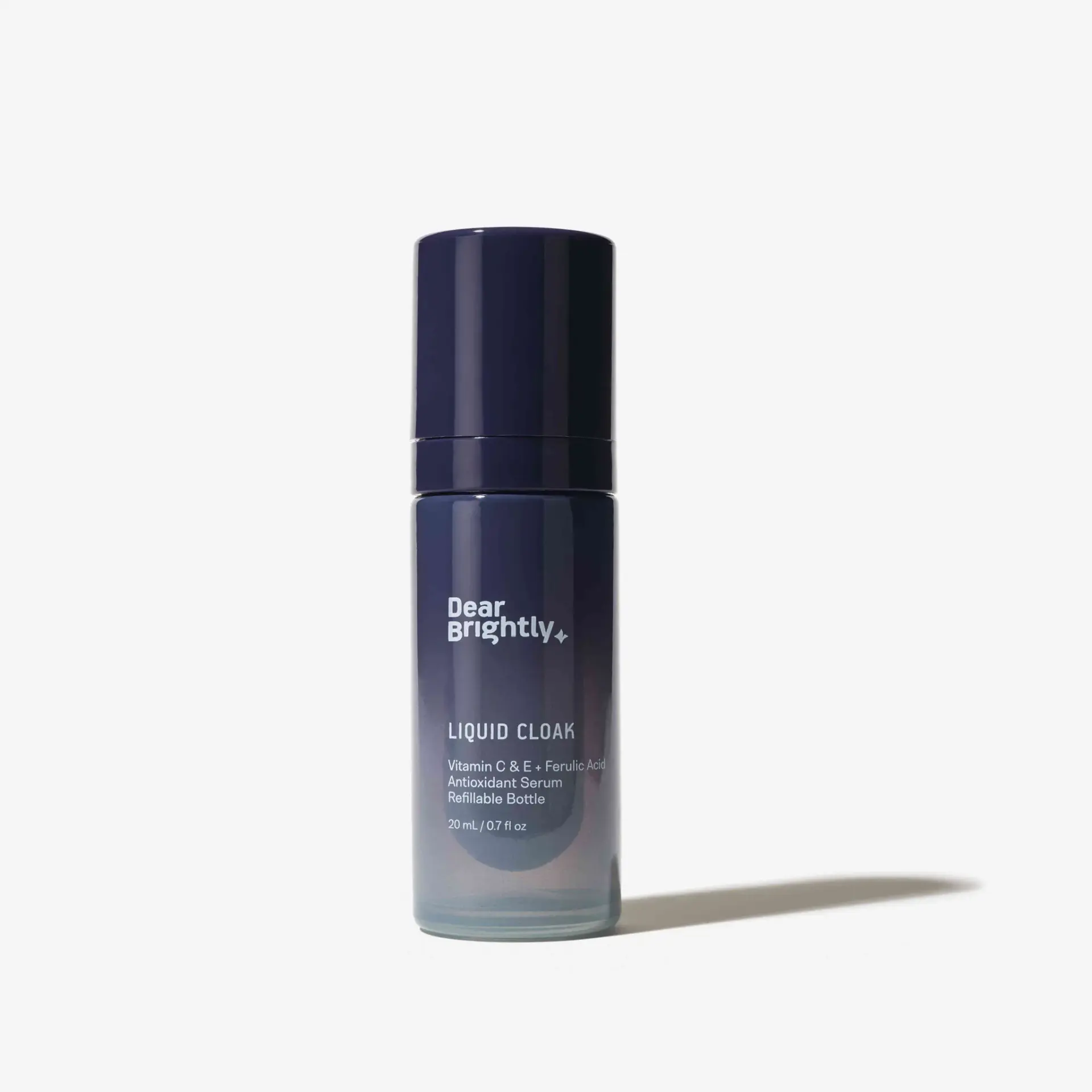 A blue bottle of Dear Brightly Liquid Cloak serum, featuring Vitamin C, E, Ferulic Acid, and Astaxanthin. The bottle is upright on a white background.